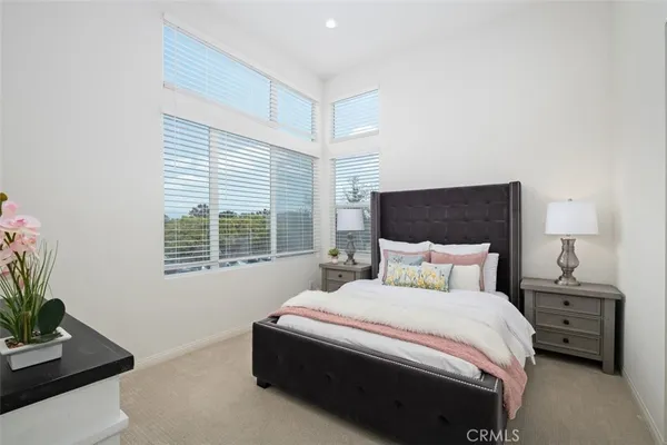 a bedroom with a bed and a potted plant