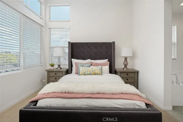 a bedroom with a bed and window