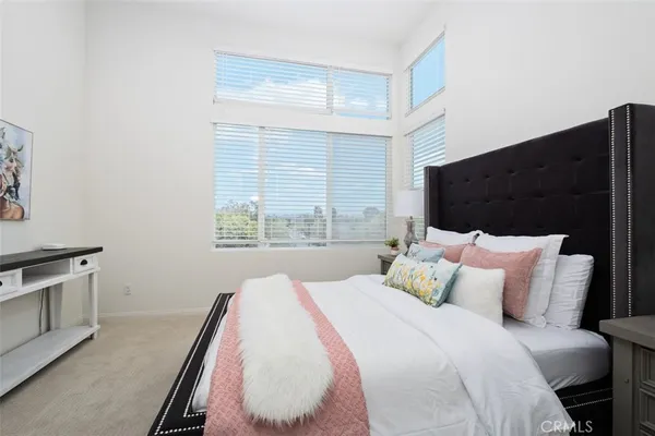 a bedroom with a bed and window