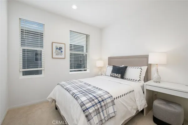 a bedroom with a bed and a chair