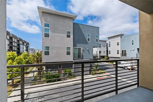 a view of a house with a wooden fence