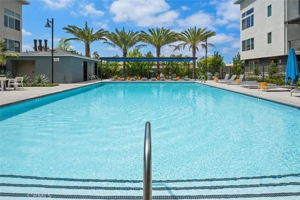 a swimming pool with outdoor seating and yard