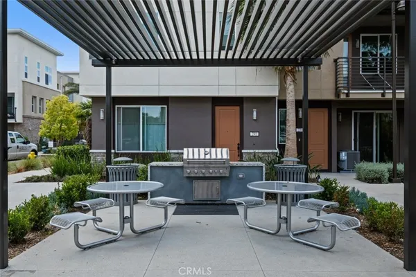 a view of a patio with a table and chairs and potted plants
