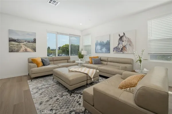 a living room with furniture and a large window