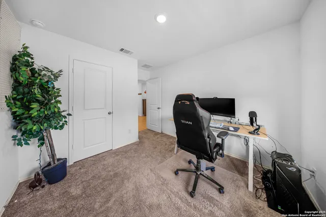 a view of a workspace with furniture and a potted plant