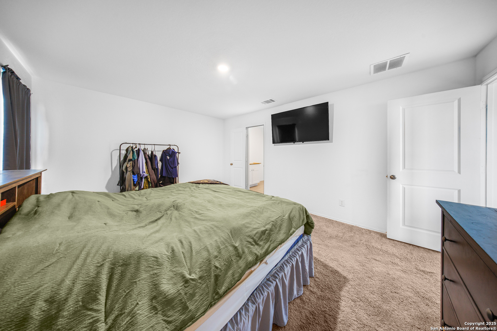 5424 Thyme Corner St. Hedwig, TX 78152 - Photo 18 of 21 a bedroom with a bed and a flat screen tv