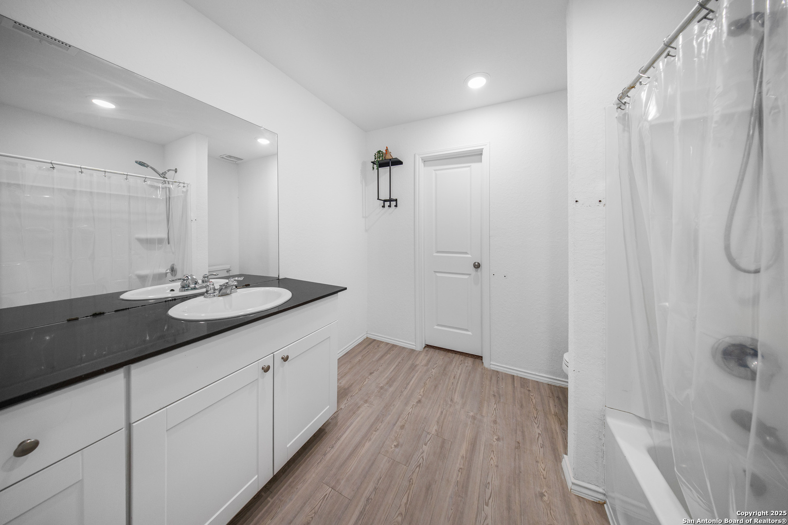 5424 Thyme Corner St. Hedwig, TX 78152 - Photo 19 of 21 a spacious bathroom with a granite countertop sink a shower and a mirror