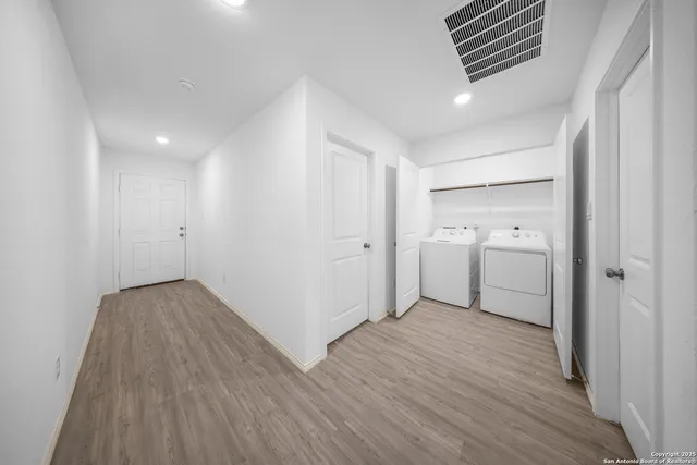 a view of hallway with wooden floor