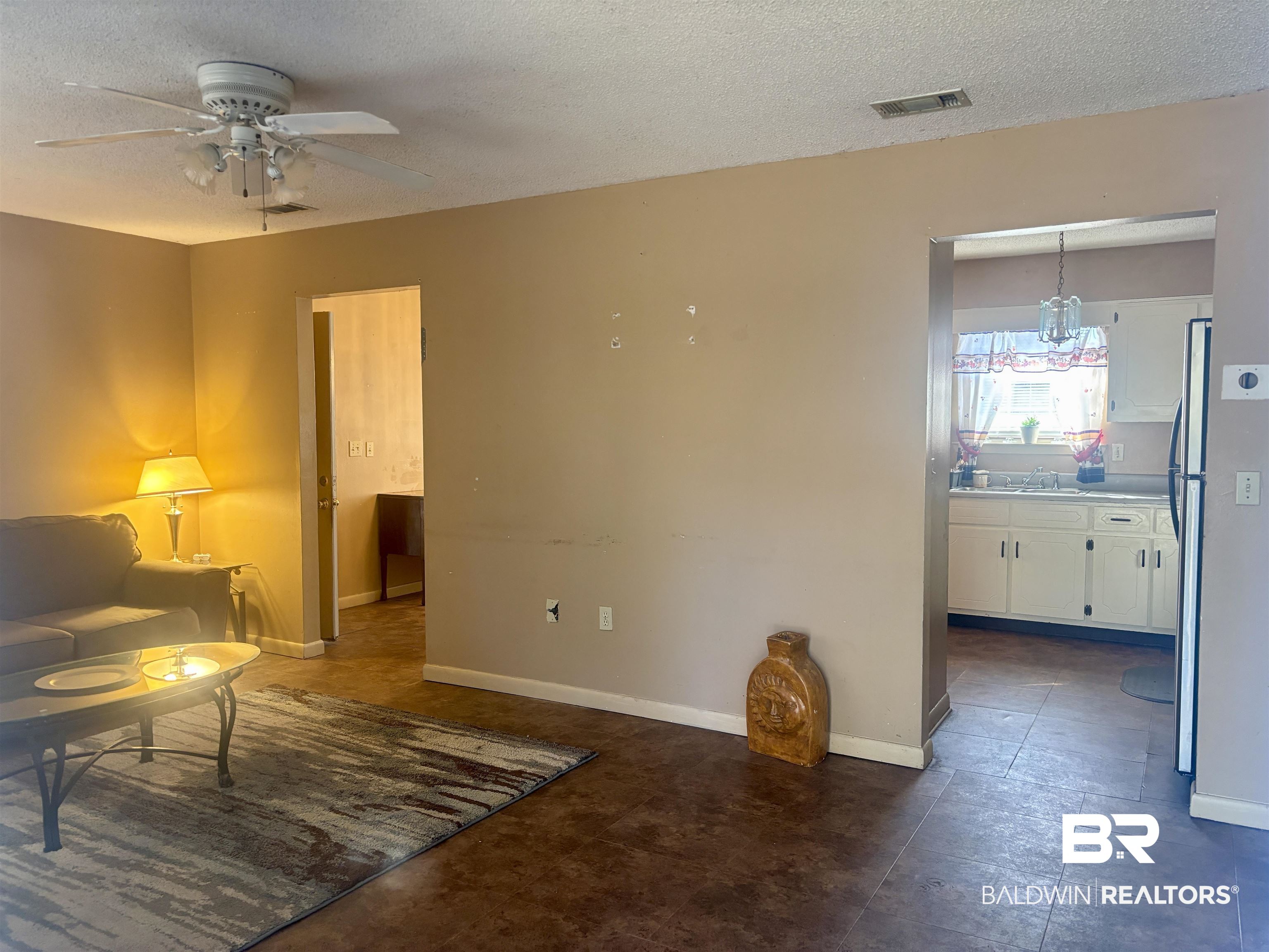 320 South Pecan Street Foley, AL 36535 - Photo 4 of 17 Living room featuring ceiling fan and a textured ceiling