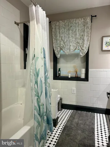 a bathroom with a bathtub and shower