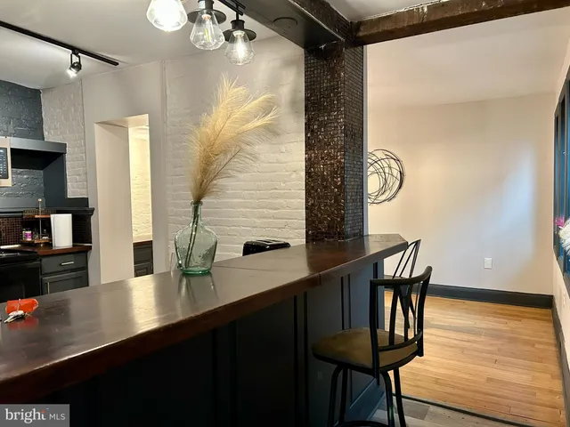 a dining room with furniture and wooden floor