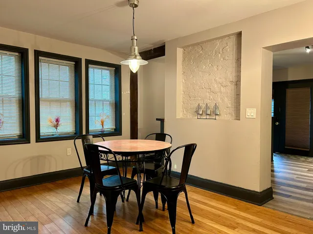 a view of a dining room with furniture window and wooden floor