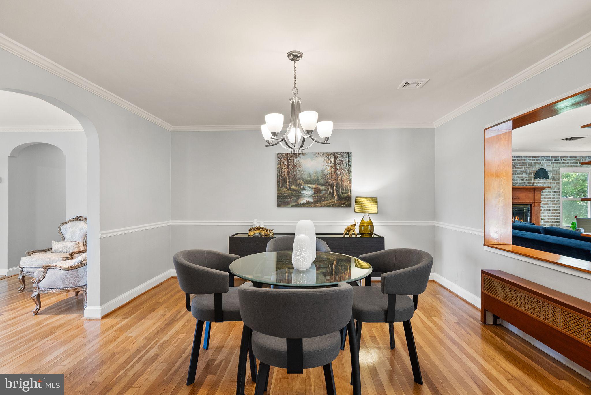 815 Seneca Road Great Falls, VA 22066 - Photo 14 of 61 a dining room with furniture a mirror and wooden floor