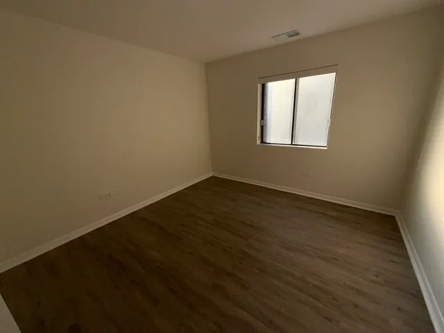 a view of an empty room with glass door