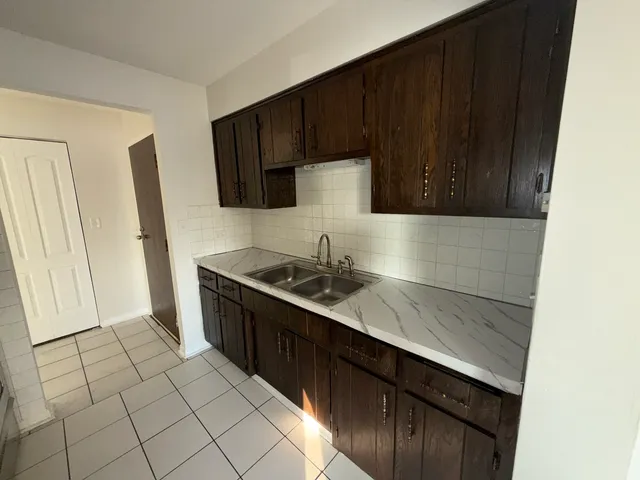 a kitchen with a sink a stove and refrigerator