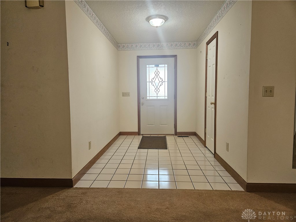 4909 Shannon Avenue Springfield, OH 45504 - Photo 4 of 21 Step into a welcoming entry featuring elegant flooring and an inviting door.