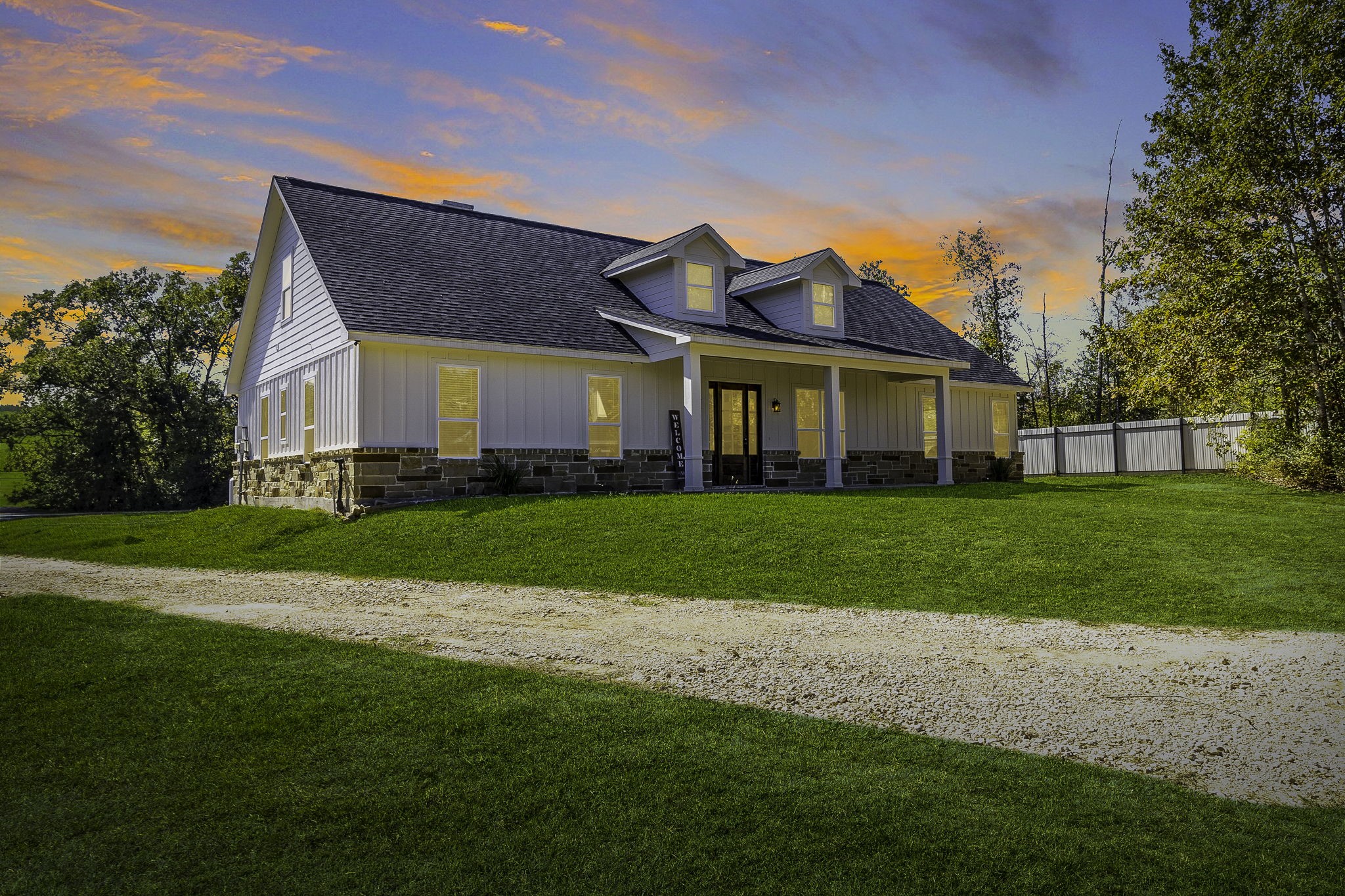 440 Farm To Market 223 Shepherd, TX 77371 - Photo 1 of 40 Beautiful modern farmhouse highlighted by stunning sunset views, showcasing the property's peaceful country setting and curb appeal