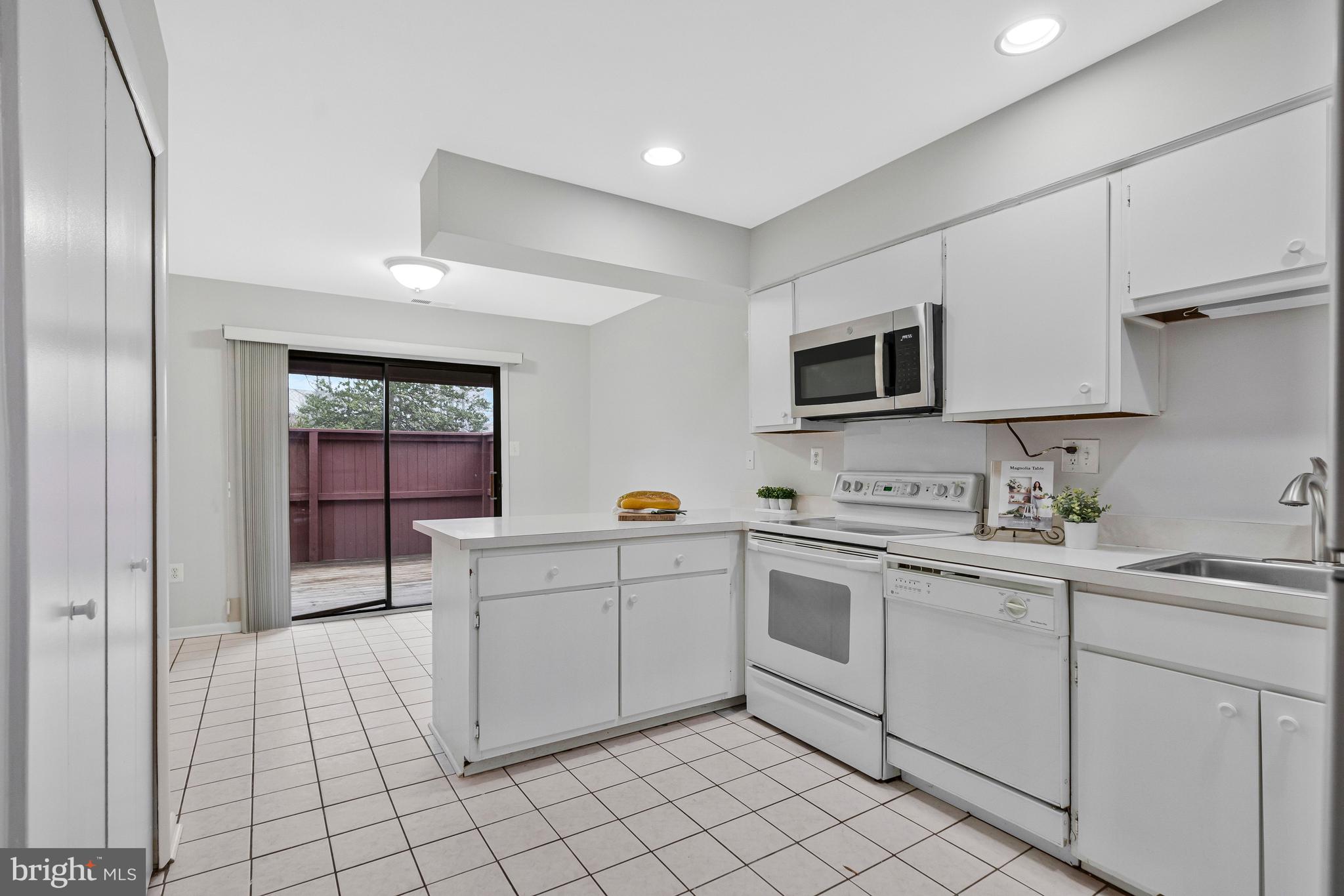 2005 Wethersfield Court Reston, VA 20191 - Photo 13 of 43 a kitchen with a sink and white cabinets