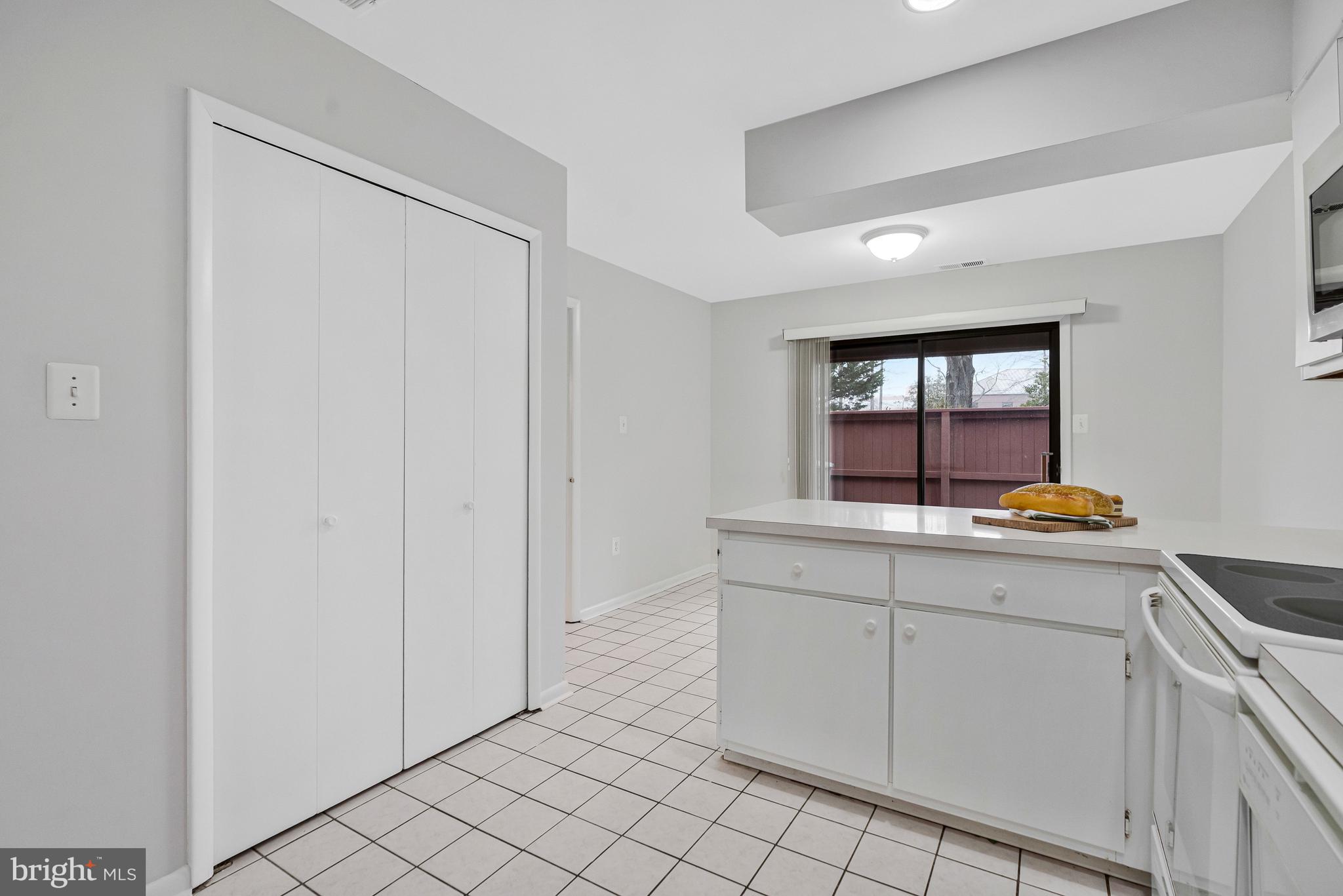 2005 Wethersfield Court Reston, VA 20191 - Photo 14 of 43 a kitchen with white cabinets and sink