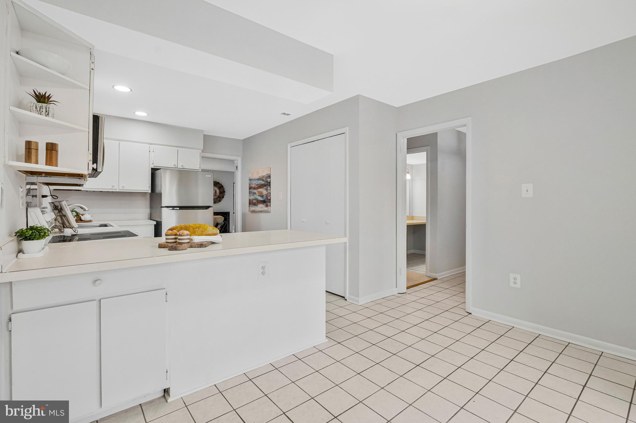 2005 Wethersfield Court Reston, VA 20191 - Photo 16 of 43 a kitchen with granite countertop white cabinets and sink