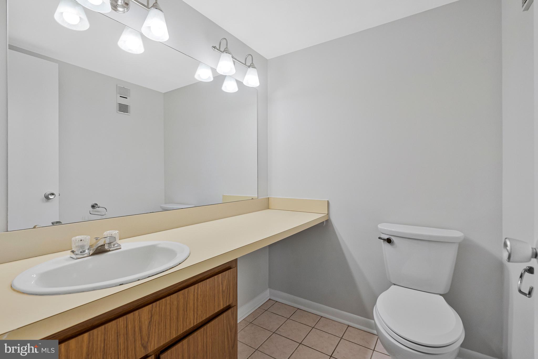 2005 Wethersfield Court Reston, VA 20191 - Photo 19 of 43 a bathroom with a sink vanity mirror and toilet