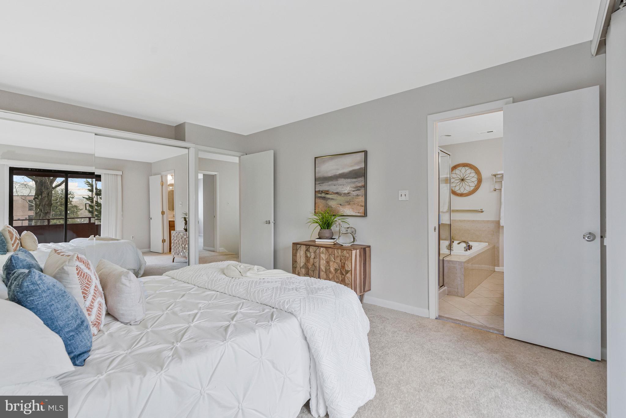 2005 Wethersfield Court Reston, VA 20191 - Photo 21 of 43 a spacious bedroom with a bed and a lamp