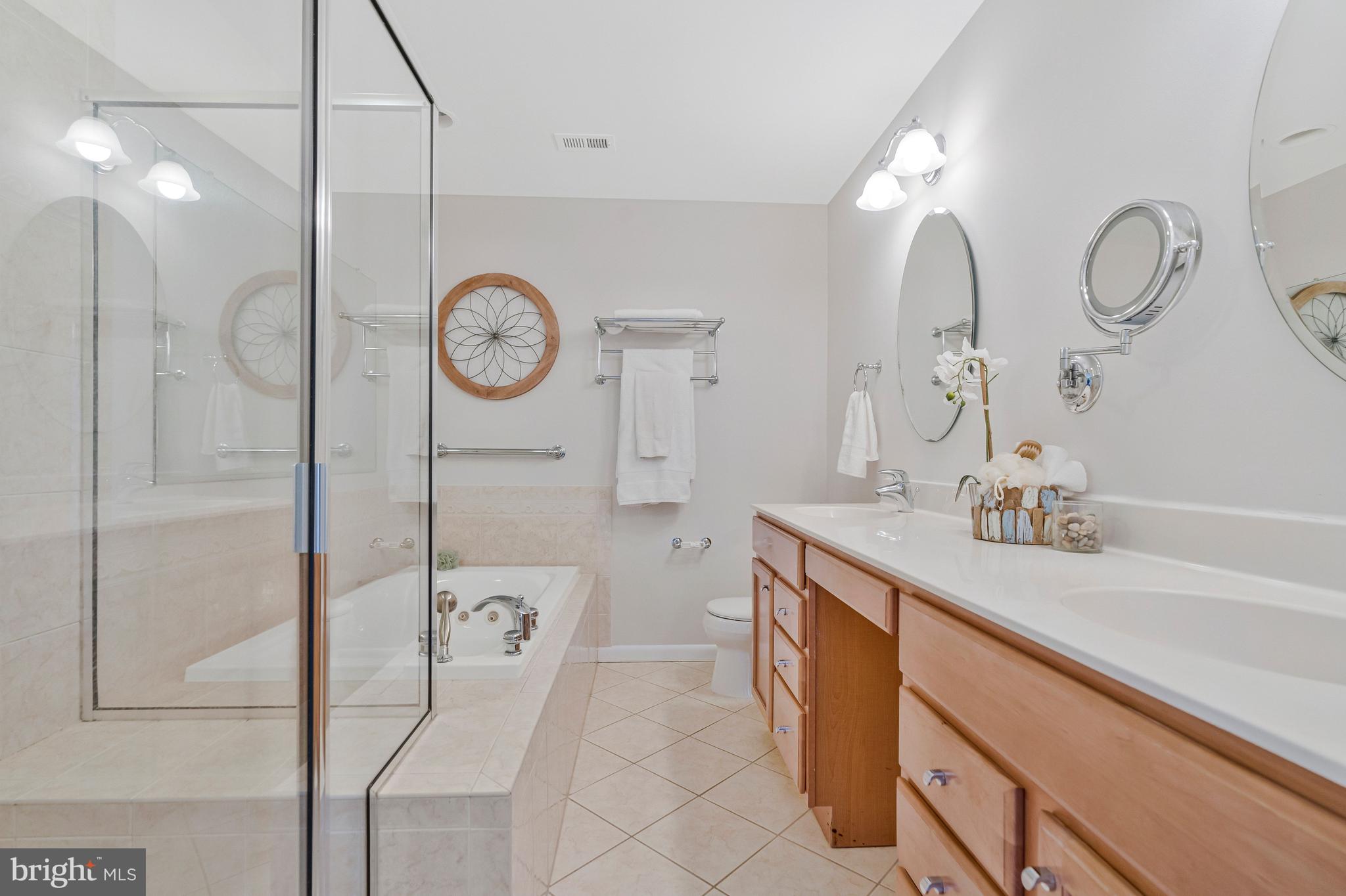 2005 Wethersfield Court Reston, VA 20191 - Photo 22 of 43 a spacious bathroom with a granite countertop sink mirror and shower