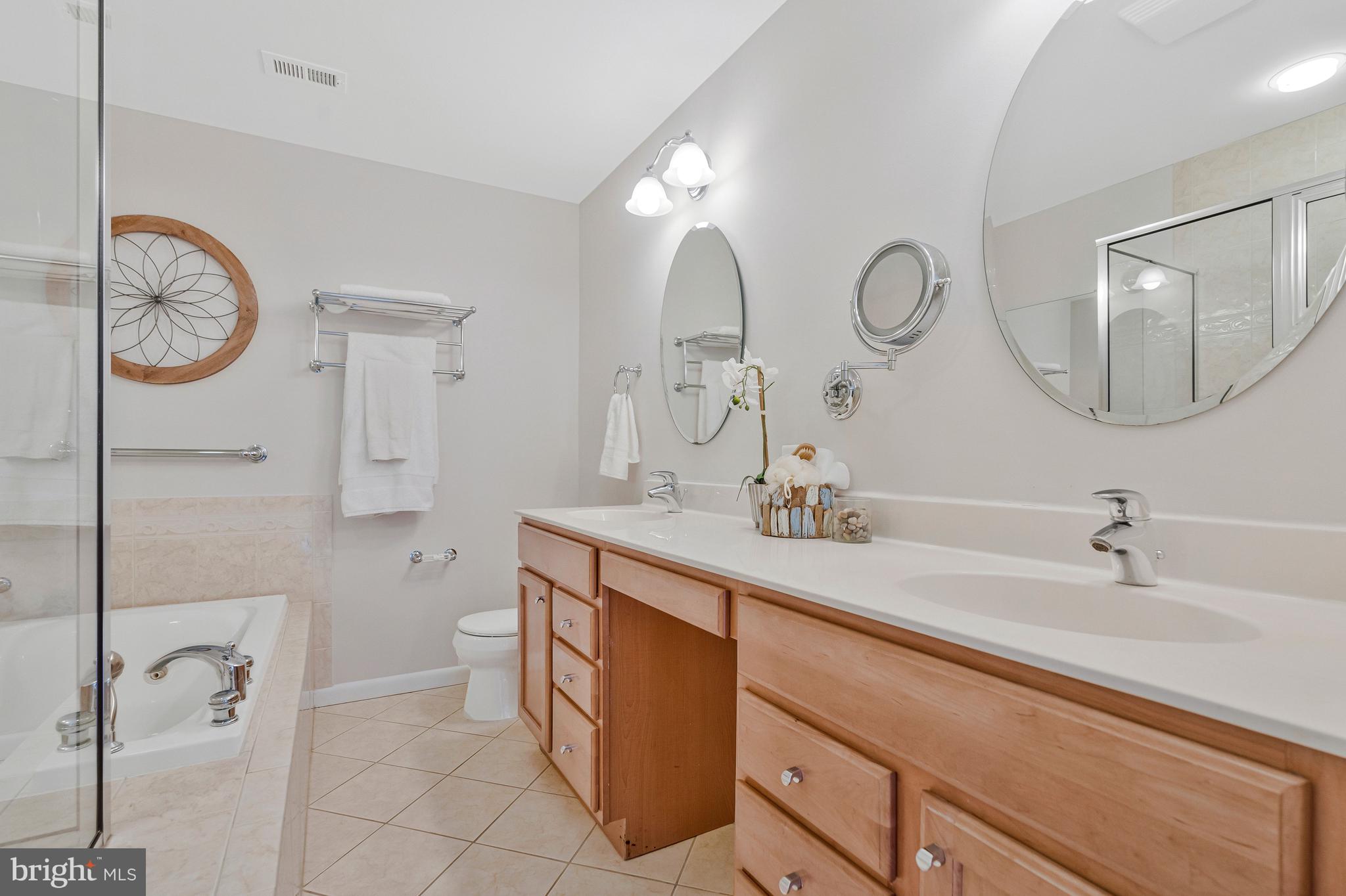 2005 Wethersfield Court Reston, VA 20191 - Photo 23 of 43 a spacious bathroom with a double vanity sink and a mirror