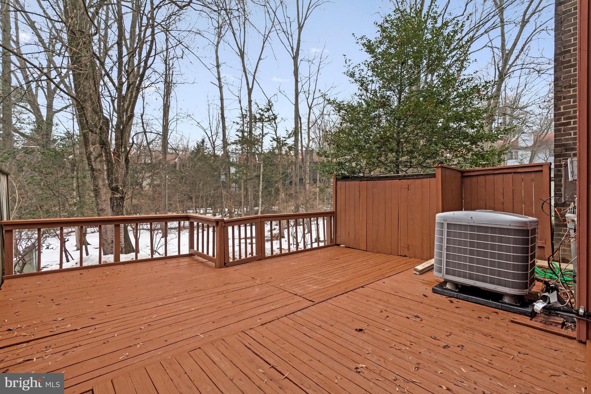 2005 Wethersfield Court Reston, VA 20191 - Photo 40 of 43 a backyard of a house with wooden deck and furniture