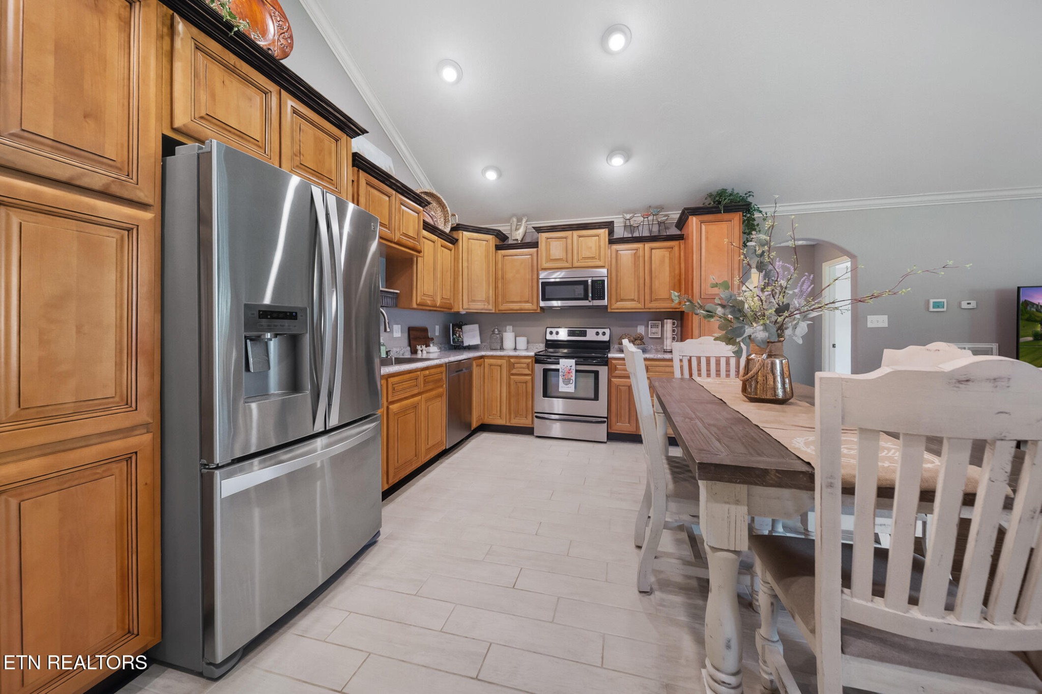 8012 Campbells Point Road Corryton, TN 37721 - Photo 13 of 39 a kitchen with stainless steel appliances refrigerator dining table and chairs