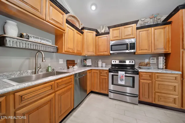 a kitchen with stainless steel appliances granite countertop a sink stove microwave and cabinets