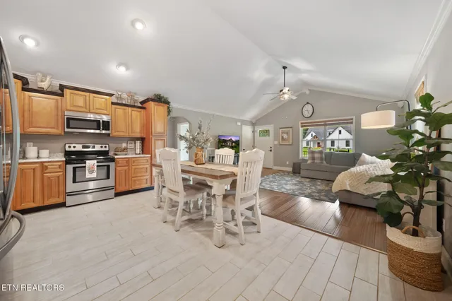 a kitchen with stainless steel appliances kitchen island granite countertop a sink and cabinets