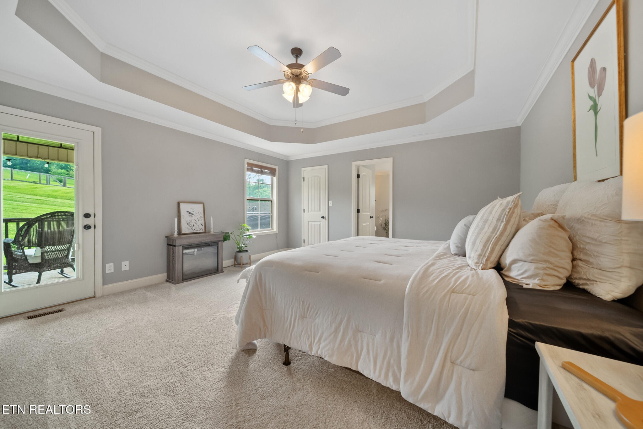 8012 Campbells Point Road Corryton, TN 37721 - Photo 18 of 39 a bedroom with a bed and a chandelier