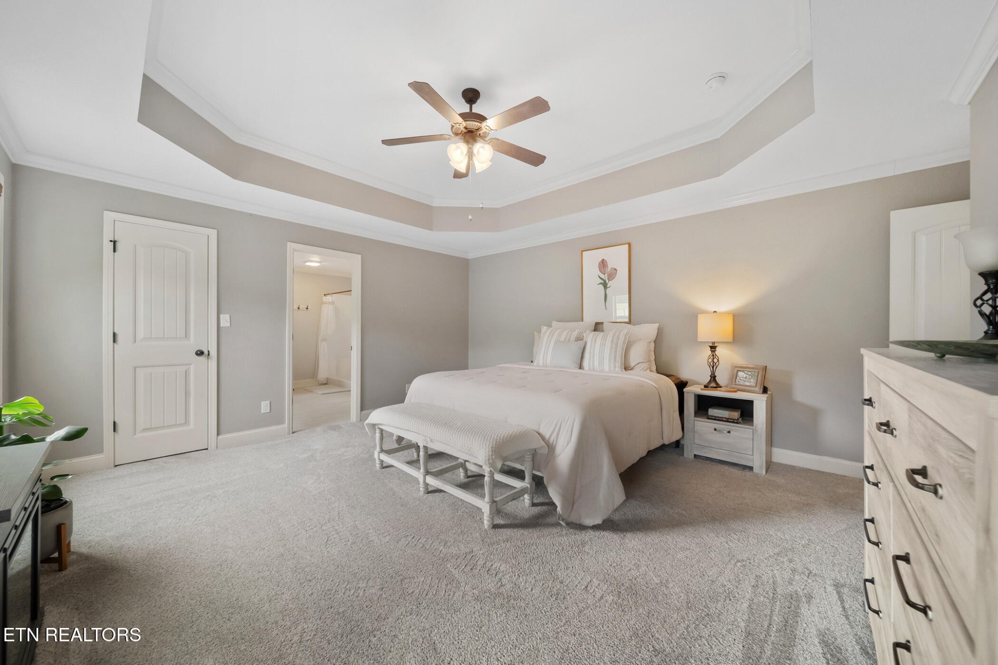 8012 Campbells Point Road Corryton, TN 37721 - Photo 20 of 39 a spacious bedroom with a bed and a chandelier