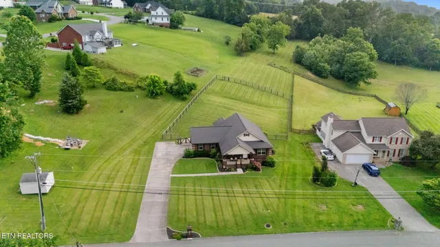 an aerial view of a house with a yard