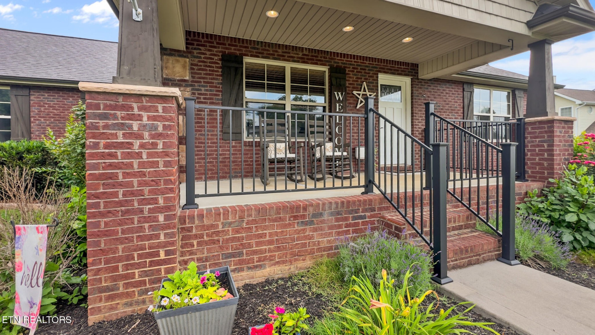 8012 Campbells Point Road Corryton, TN 37721 - Photo 6 of 39 a view of a house with wooden fence and potted plants