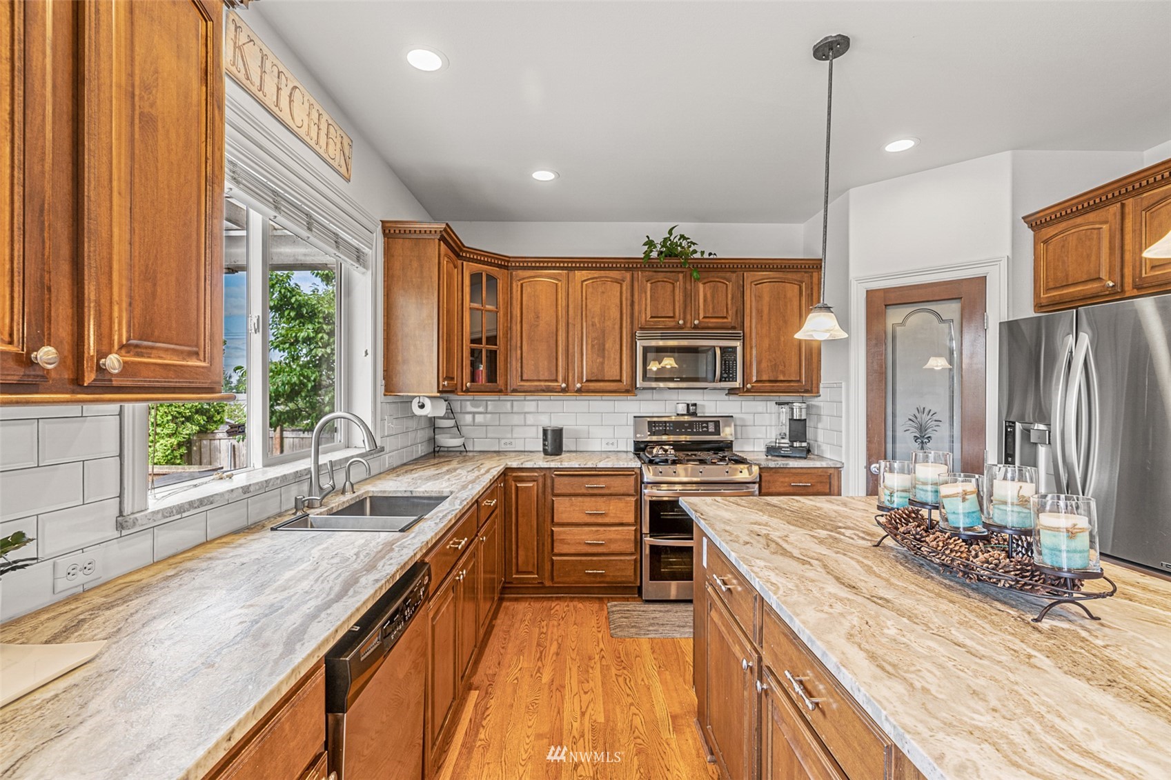 659 Orcas Avenue Northeast Renton, WA 98059 - Photo 17 of 40 a large kitchen with granite countertop a large window and stainless steel appliances