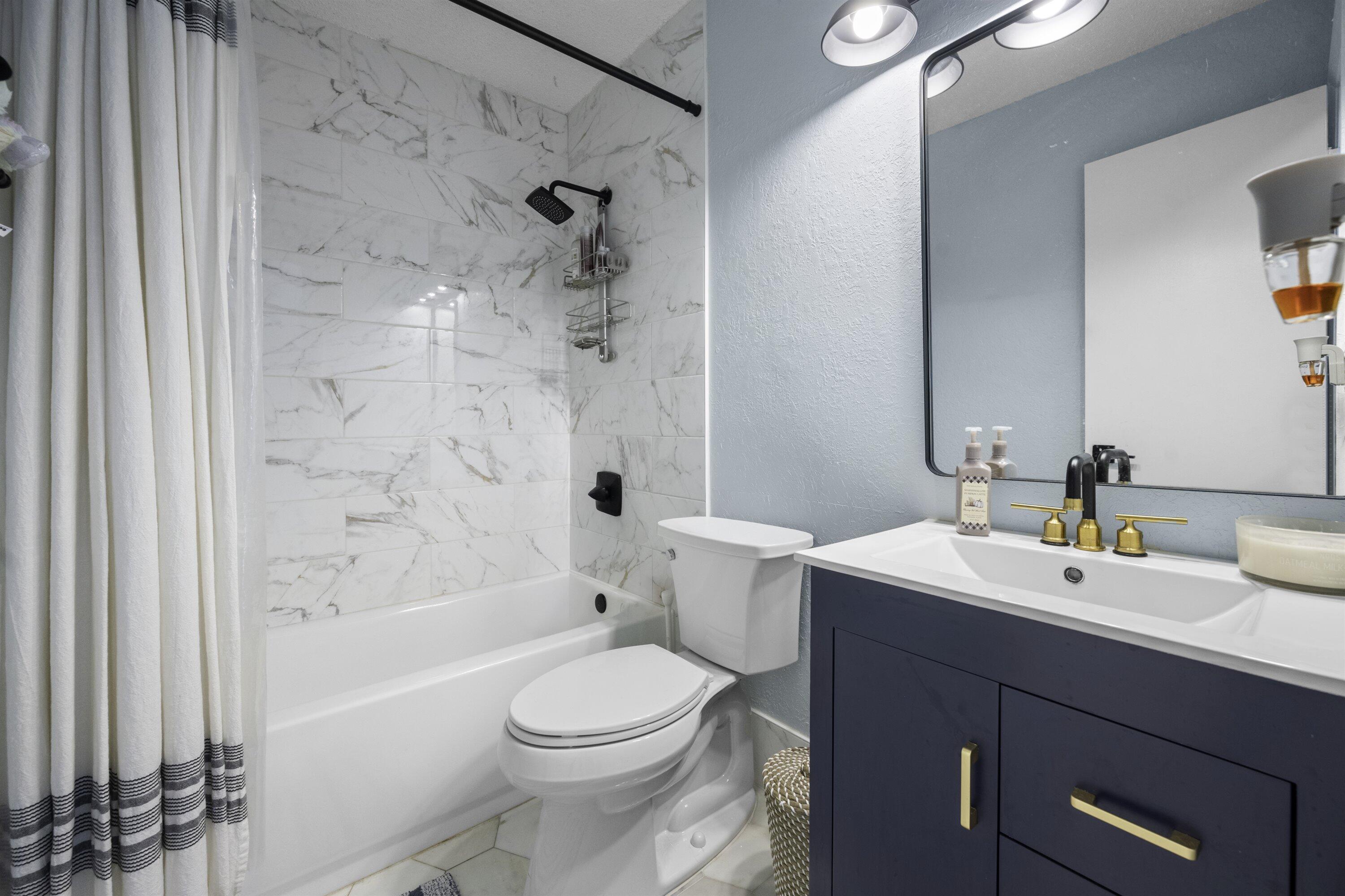 197 Southeast 1st Circle, Unit 15B Boynton Beach, FL 33435 - Photo 19 of 26 a bathroom with a sink a toilet and shower