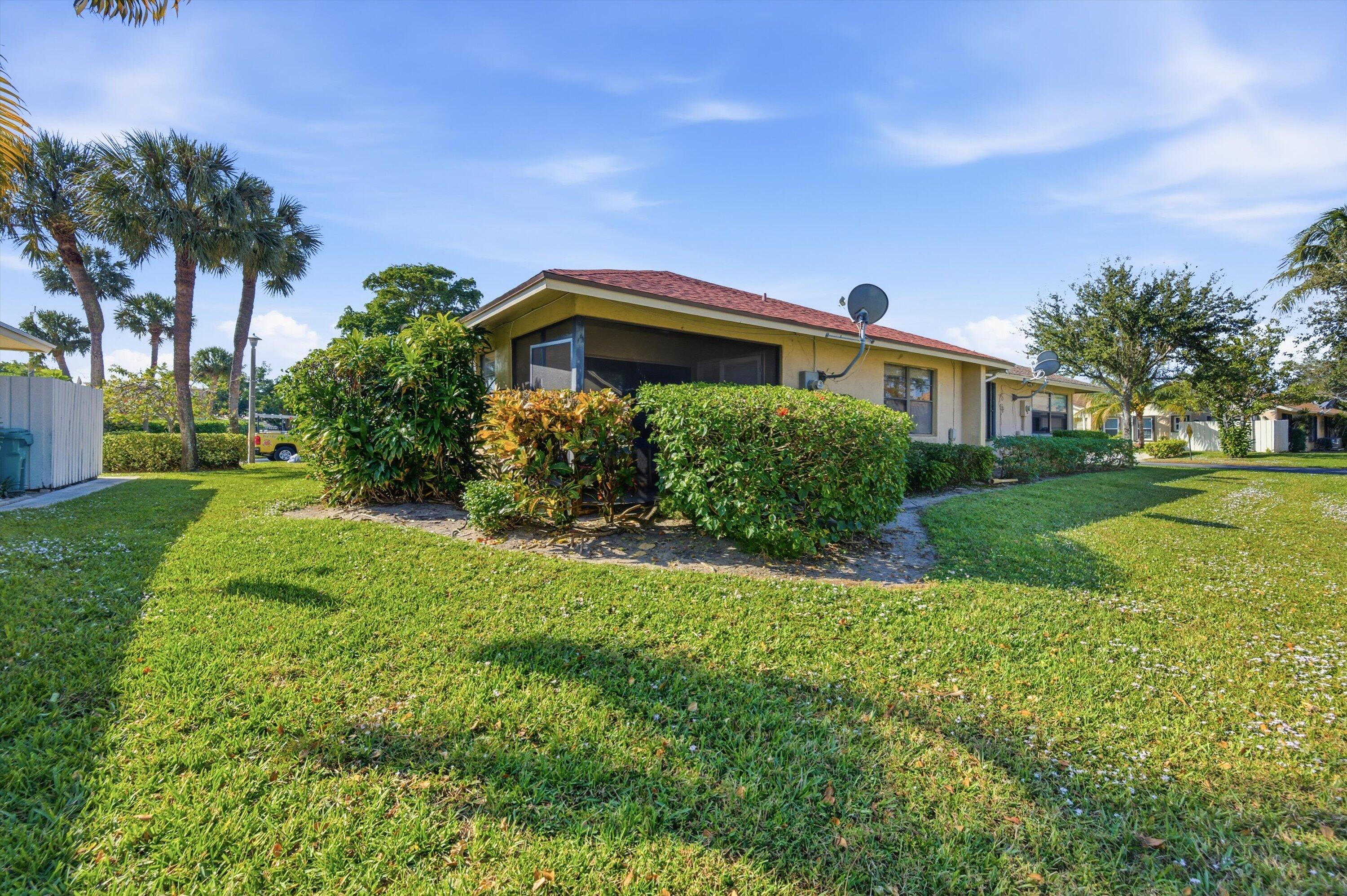 197 Southeast 1st Circle, Unit 15B Boynton Beach, FL 33435 - Photo 21 of 26 a front view of a house with a yard