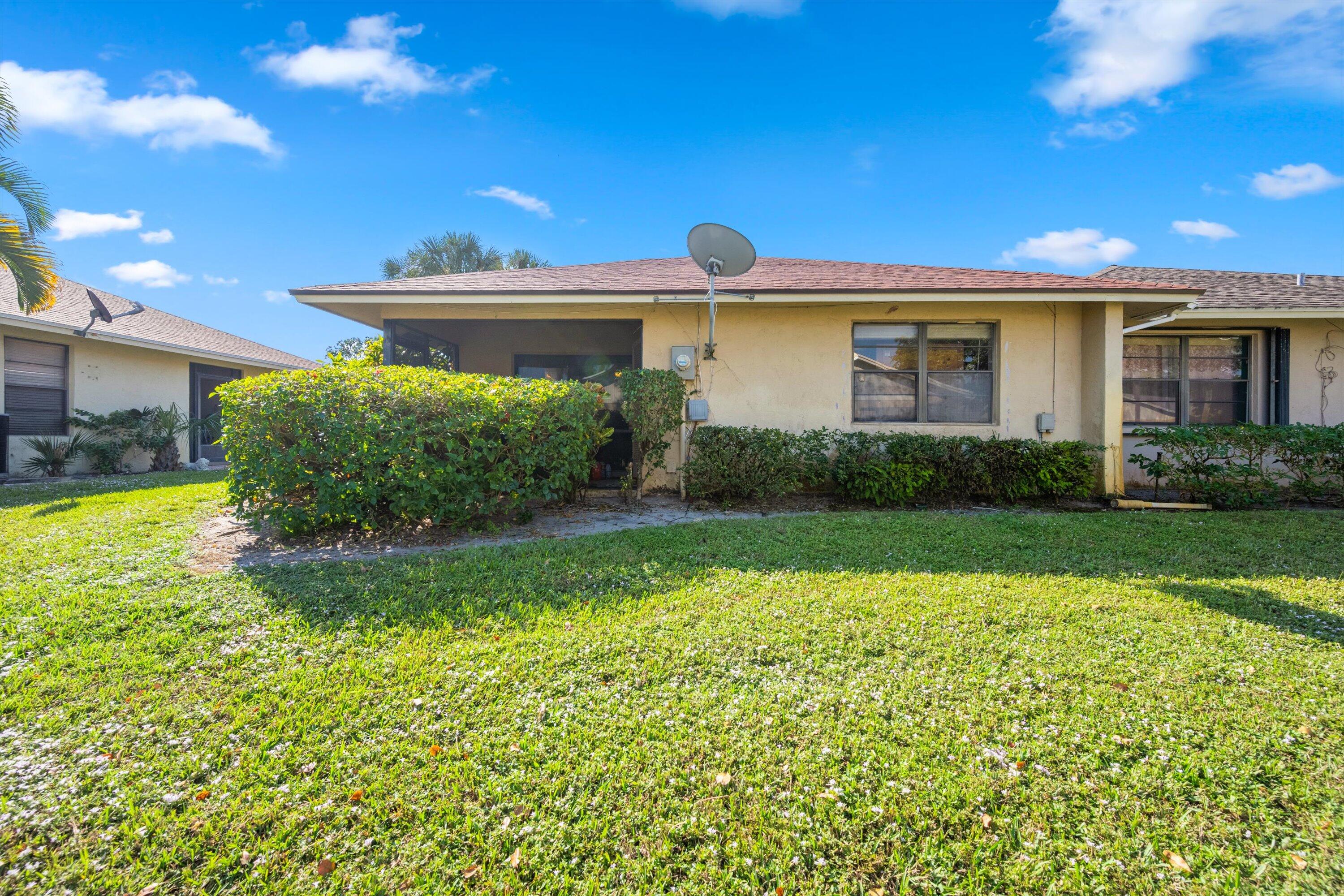 197 Southeast 1st Circle, Unit 15B Boynton Beach, FL 33435 - Photo 22 of 26 a front view of a house with garden