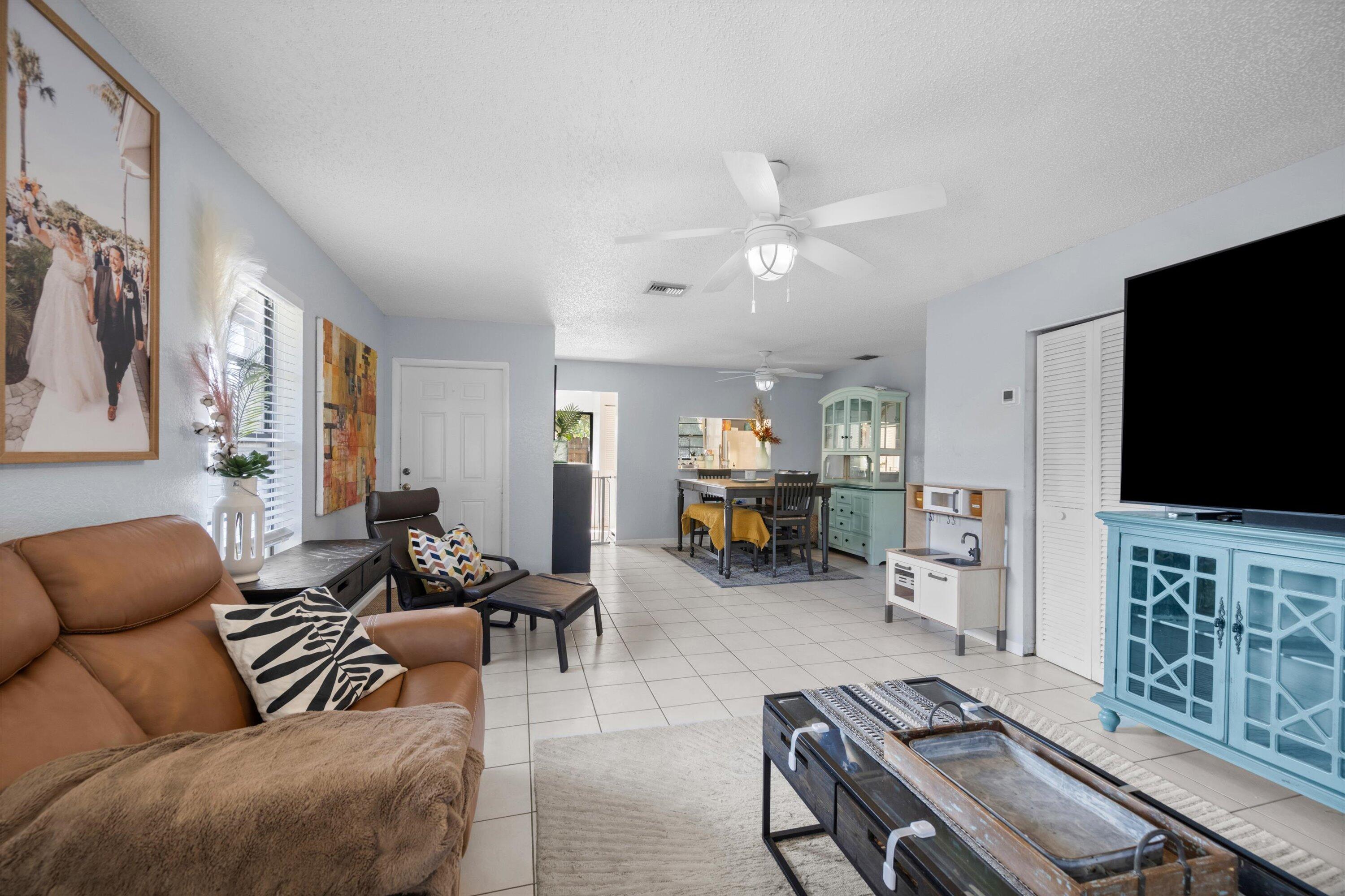 197 Southeast 1st Circle, Unit 15B Boynton Beach, FL 33435 - Photo 7 of 26 a living room with furniture and a flat screen tv