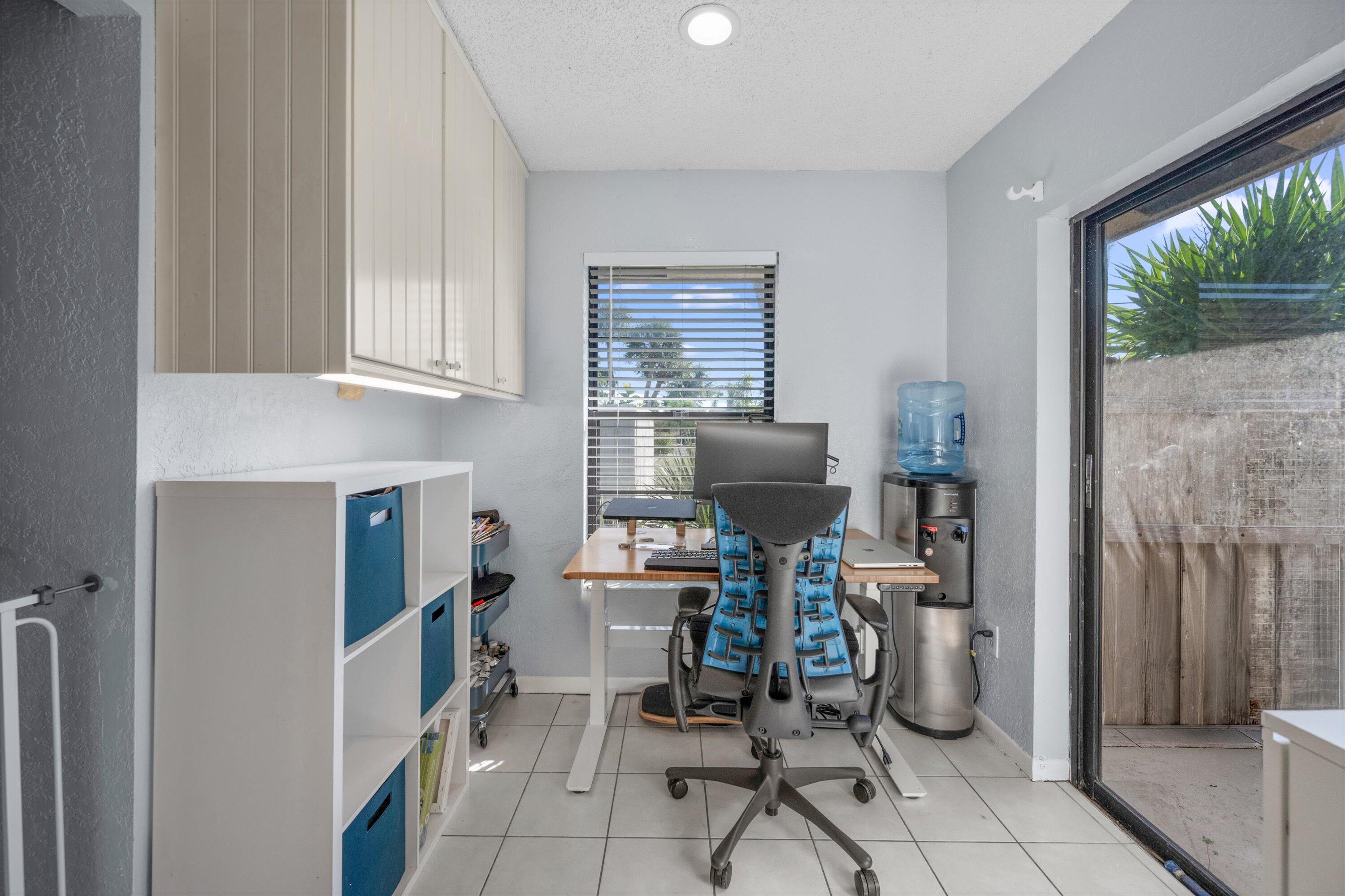 197 Southeast 1st Circle, Unit 15B Boynton Beach, FL 33435 - Photo 10 of 26 a view of a workspace with furniture and a window