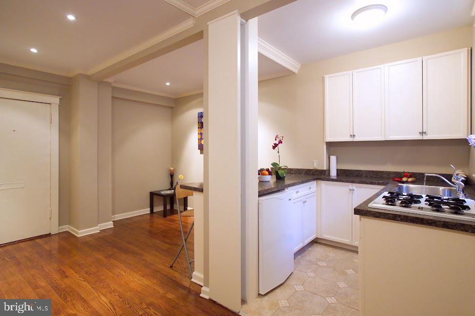1457 Park Road Northwest, Unit 404 Washington, DC 20010 - Photo 3 of 8 a kitchen with sink refrigerator and stove