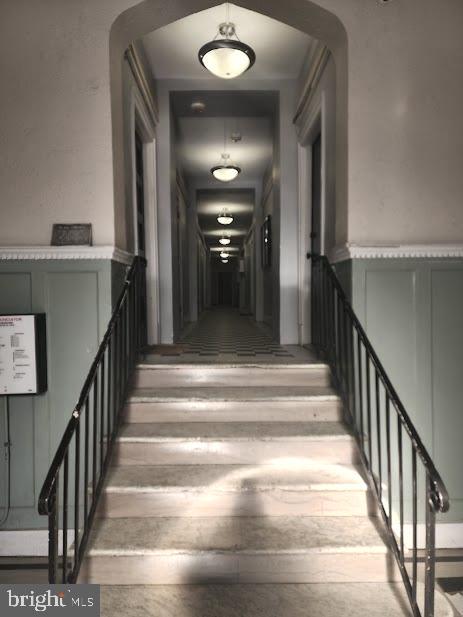 1457 Park Road Northwest, Unit 404 Washington, DC 20010 - Photo 7 of 8 a view of staircase with railing and a chandelier