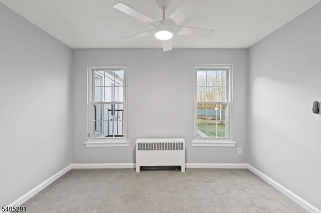 an empty room with windows and closet