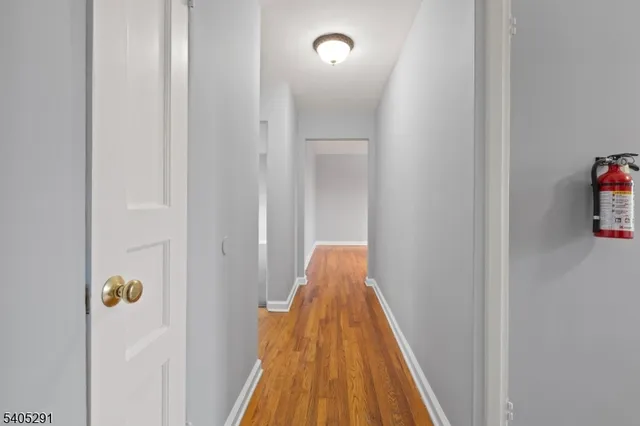 a view of hallway with wooden floor