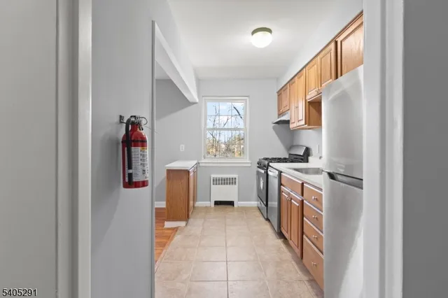 a kitchen with a stove top oven sink and cabinets