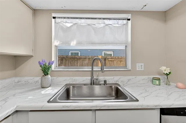 a bathroom with a sink a toilet and shower curtain