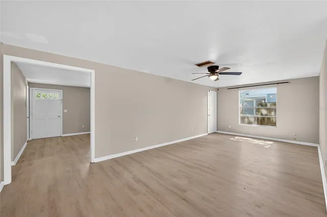a view of a livingroom with workspace and a window