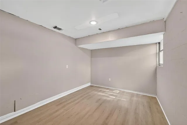 a view of a house with a yard and large tree